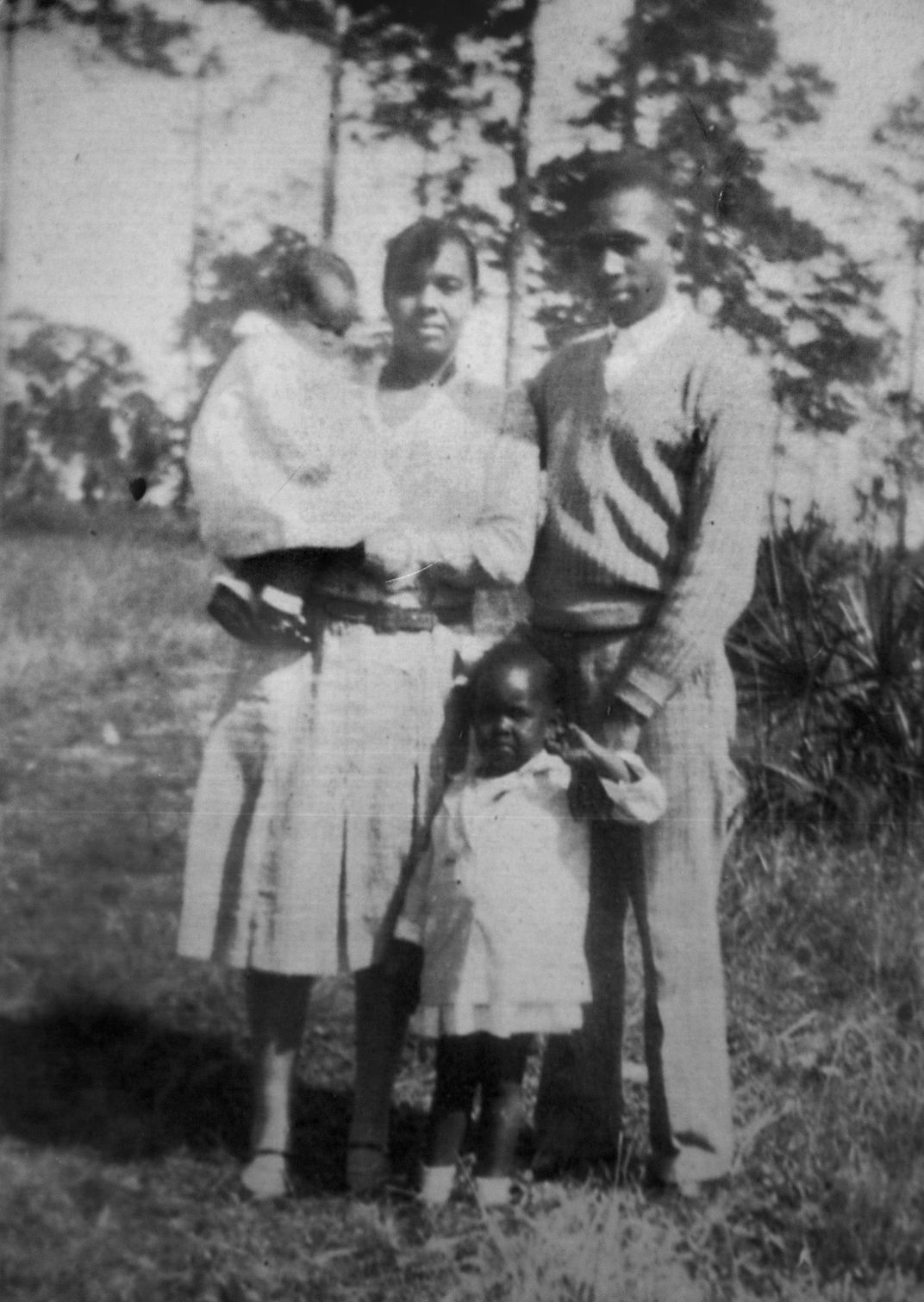 Harriette holds Evangeline while Annie stands in the foreground next to Harry in this 1931 family photo.