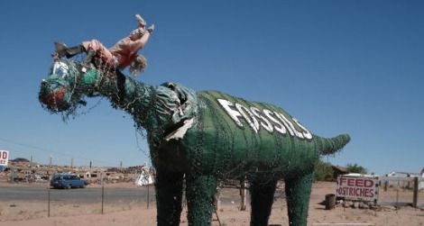 One of the sad dinosaurs at Stewart's Petrified Wood near Petrified Forest National Park in Arizona.
