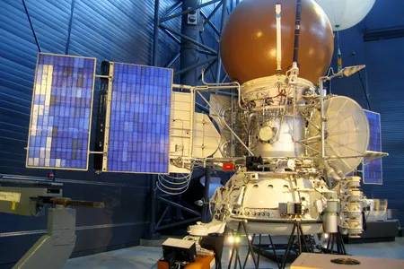 A model of the Soviet VEGA Venus spacecraft, with the white atmospheric balloon peeking out from behind.
