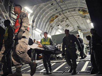 Wounded service members are taken off a C-17