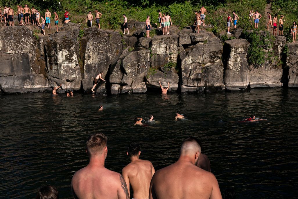 Cliff divers line up along the Clackamas River at High Rocks Park at on June 27, 2021 in Portland, Oregon
