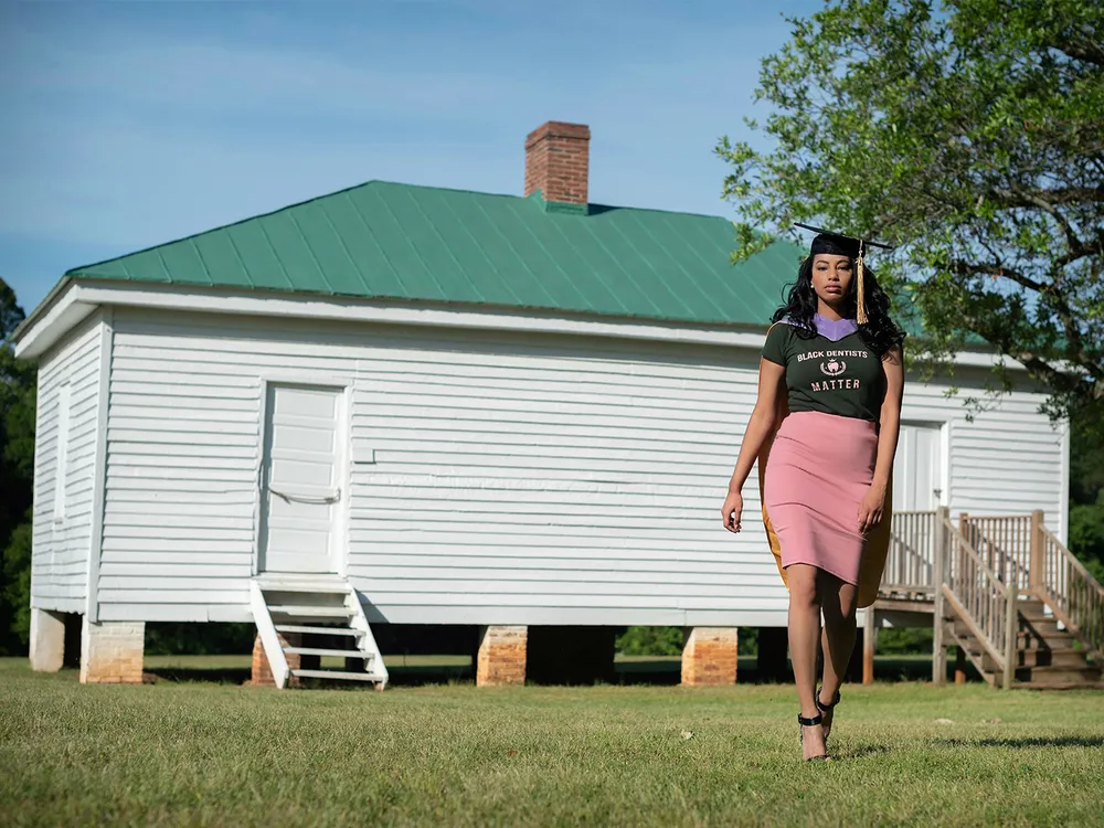 Breanna Henley poses in front of a slave cabin at Redcliffe Plantation in 2021