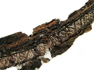 A Viking-age woven band of silk displays patterns in silver thread discovered to be Arabic script