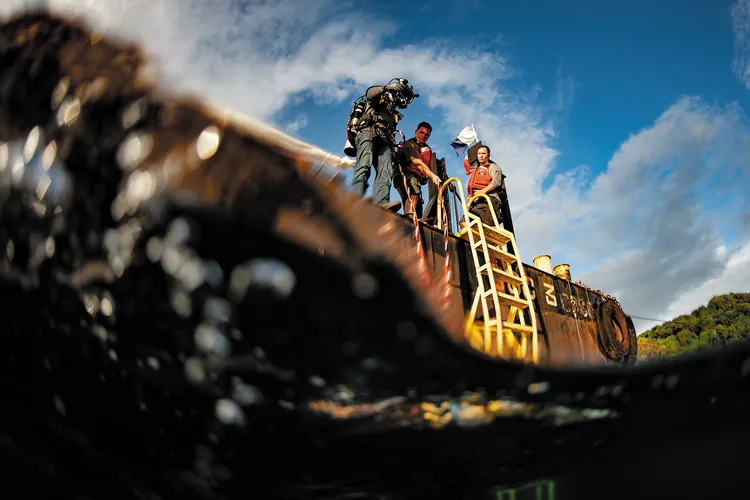 OPENER - A diver prepares to enter the water of Malakal Harbor in Palau, where the plane flown by U.S. Navy pilot Jay Ross Manown Jr. was shot down in September 1944.