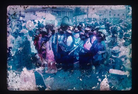 blue and purple tinted photo of a group of New Orleans residents