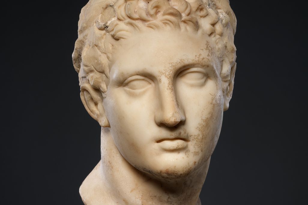 A marble head of a horned youth wearing a diadem ("Marble Head of a Horned Youth"), dated 300-100 B.C.