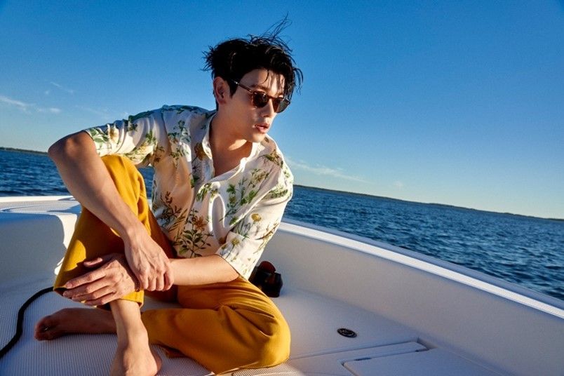 Eric Nam sitting on a boat in the ocean