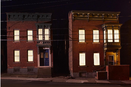 These seemingly inhabited buildings are actually vacant properties illuminated by the new Breathing Lights project in three New York cities.