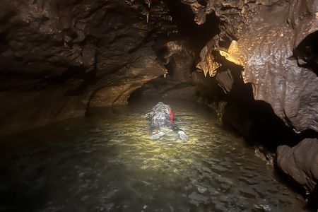 Two researchers wore goggles, snorkels and wet suits while exploring the underground stream.