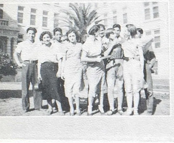 Group of teenagers in front of a school building.