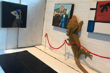 The Mayor, a crested gecko, takes a feet-on approach to appreciating art.