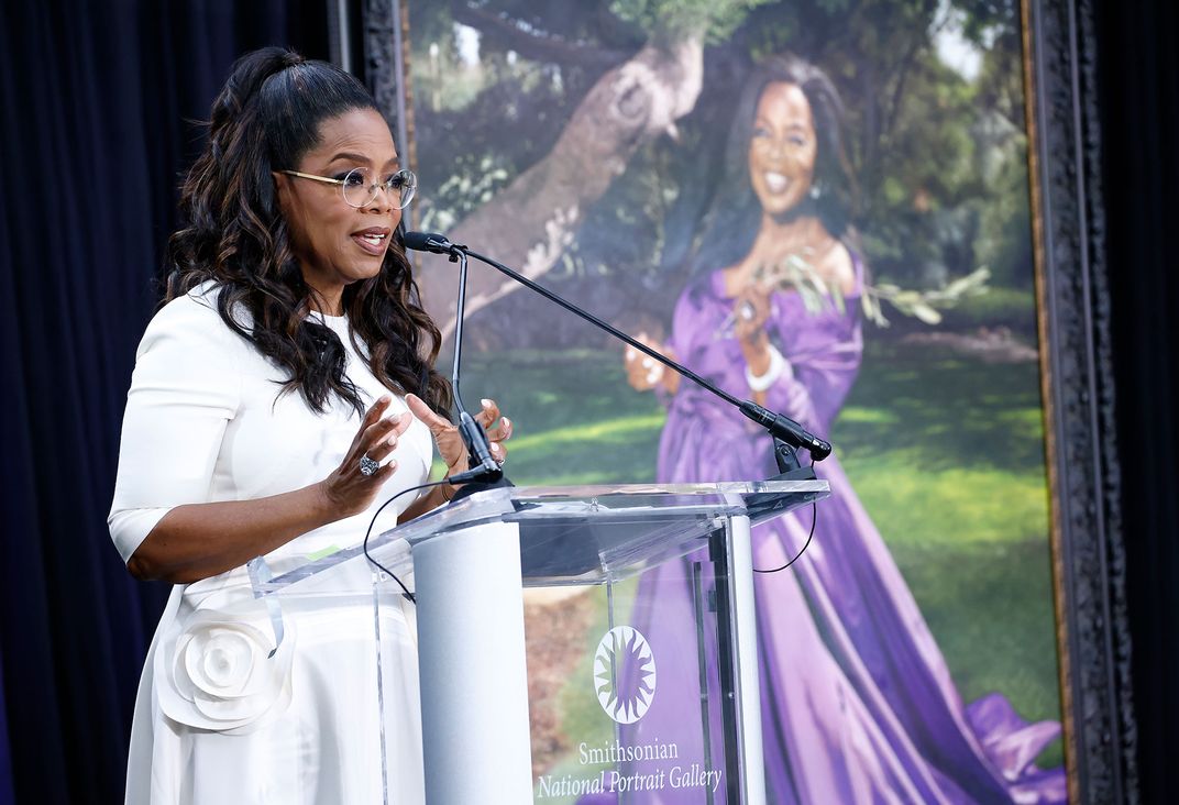 Oprah Winfrey in front of her newly unveiled portrait