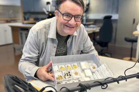 Erlend Bore poses with the trove that he found soon after buying his first metal detector.
