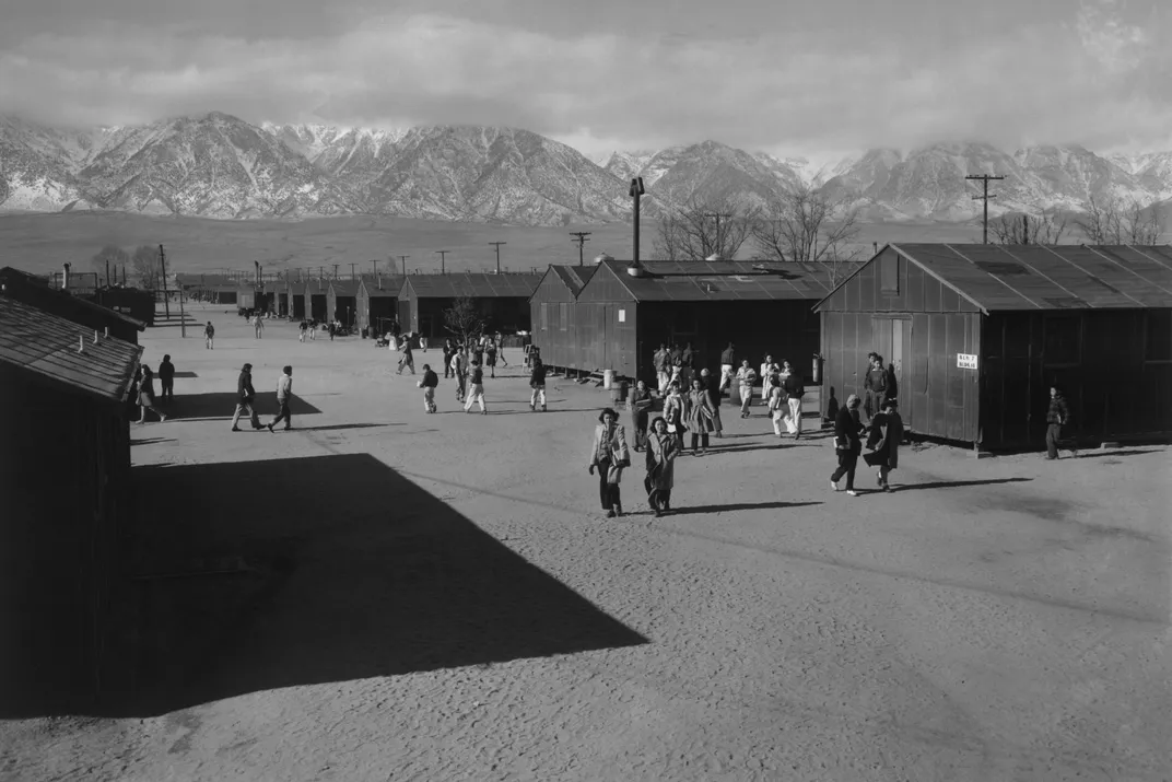 students walk in between buildings at Manzanar Relocation Center