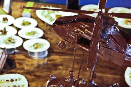 U.S. Army Pvt. Nicholas Marker of Fort Campbell, Ky., constructs a chocolate helicopter, that sits on display at the 36th Culinary Arts competition on Fort Lee, Va., March 5, 2011. The chocolate center piece is displayed as part of the cold foods table category in which Marker received a bronze medal. (U.S. Army photo by Spc. Courtney Lindsay/Released)