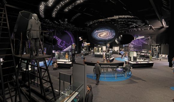 An artist's renderign of a cavernous museum exhibit space with a dark ceiling illuminated by images of bright white stars and a spiral galaxy. On the floor of the gallery, numerous visitors wander past glass display cases filled with artifacts.