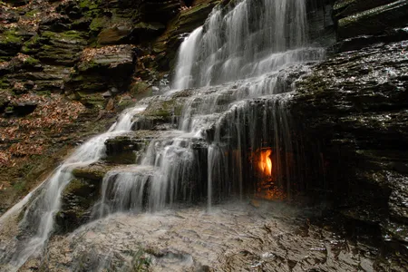 This small, bucolic waterfall in Western New York has one highly photogenic feature: a grotto lit by a dancing orange flame.