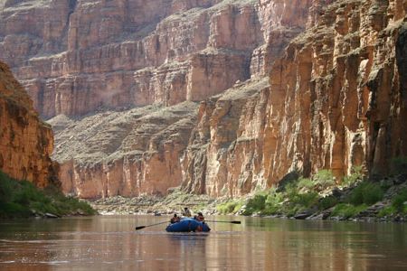 A group of boaters make their way down the peaceful Colorado River in the Grand Canyon.