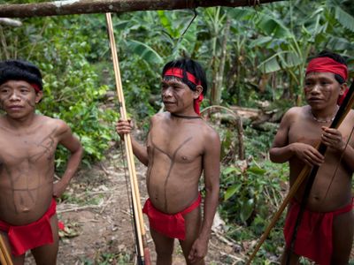 Several Yanomami at the community of Irotatheri, in Venezuela, wait to preform a dance for visiting journalists