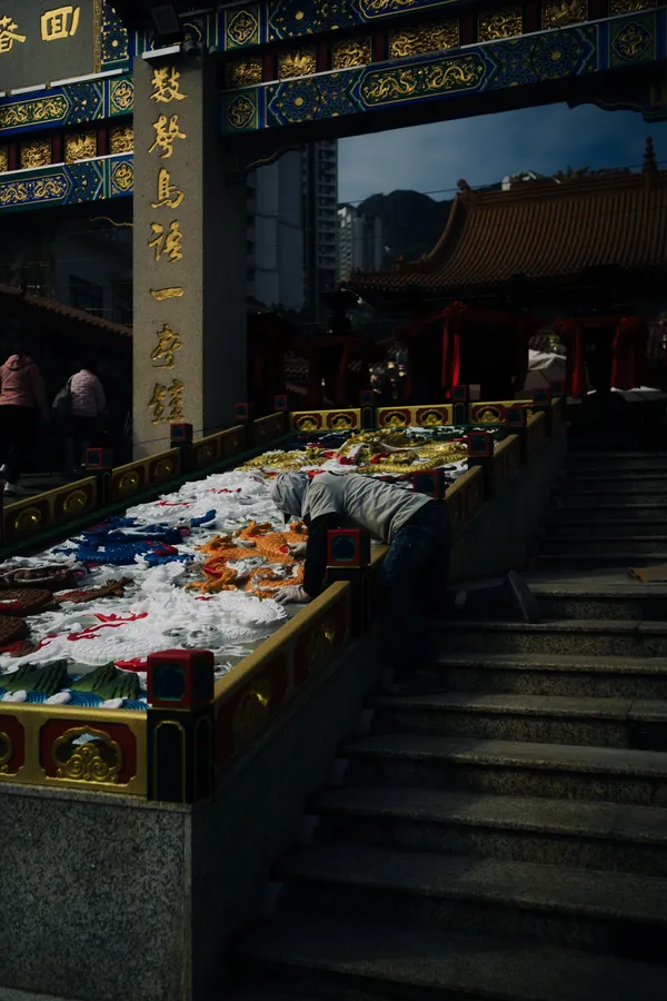 An attendant cleans the temple's ornate stairwell thumbnail