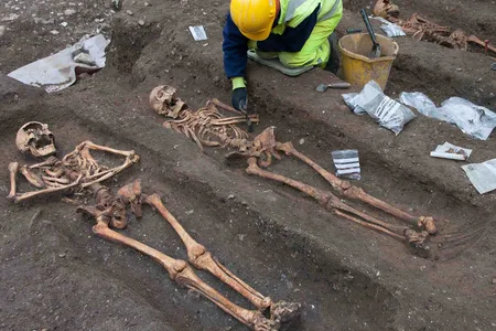 Archaeologists excavate the remains of friars buried at the former Augustinian friary in central Cambridge.