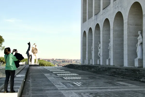 A tourist photographing the sculptures in an old Roman building thumbnail