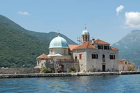 On the Bay of Kotor, young men motor travelers out to “Our Lady of the Rocks” Church.