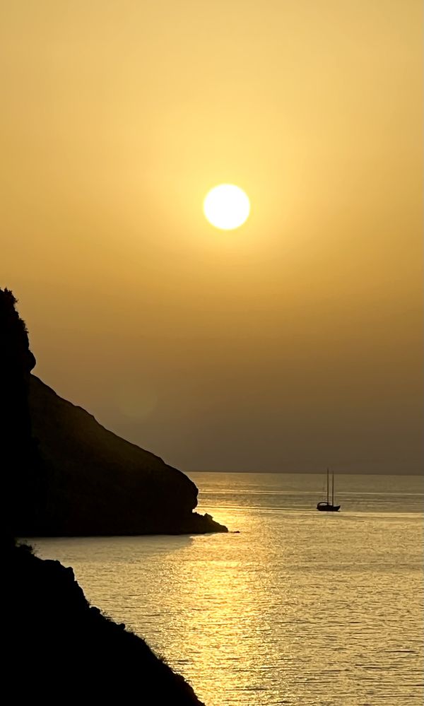 Sun sets on a sailboat thumbnail
