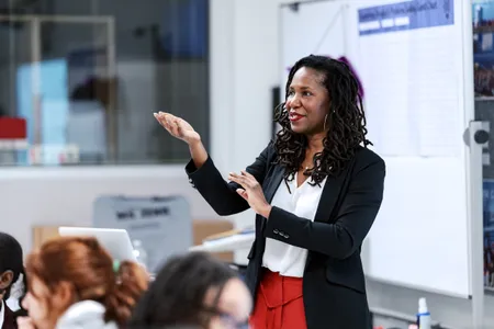 Summer Hamilton stands in front of a classroom gesturing.