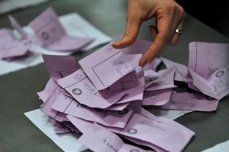 Precinct officials count paper ballots for Mitt Romney in the 2012 Iowa caucuses.
