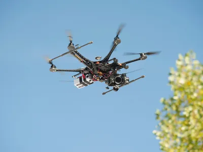 An unmanned Aerial Vehicle (UAV) / drone used for aerial surveillance is flying in the air.