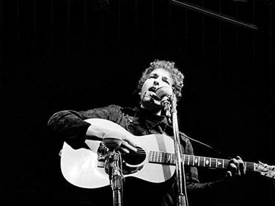 Bob Dylan at the Newport Folk Festival in 1964 where he was an acoustic icon. The following year, he went electric.