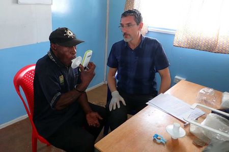 Working with the Papuan Past Project, François-Xavier Ricaut measures the lung function of a highlander study participant at St. Therese’s School at Denglagu mission.