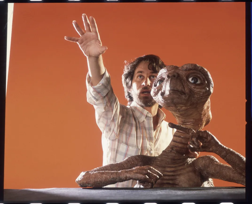 Spielberg poses with E.T. in 1982.