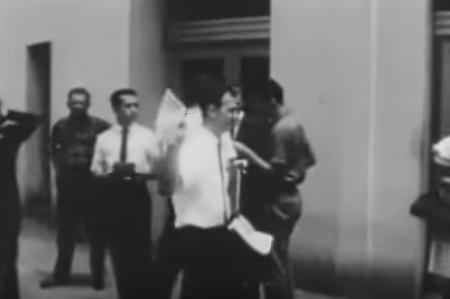 Lee Harvey Oswald, center, handing out fliers. According to a conspiracy theory floated by the National Enquirer, the unidentified man on the left wearing a black tie is the father of Senator Ted Cruz.