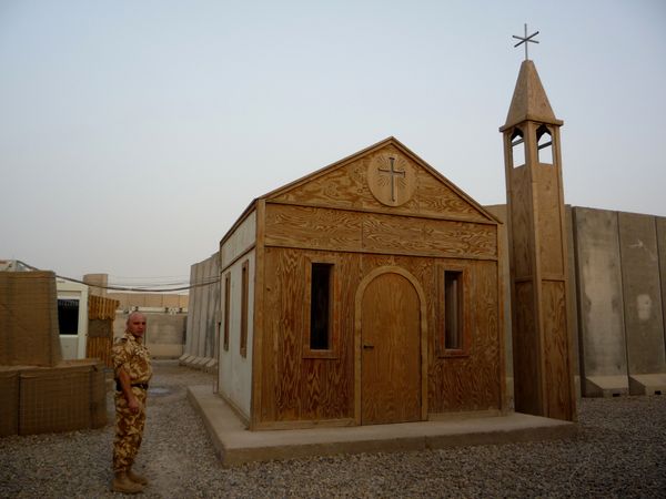 A plywood chapel stands out amidst the monochrome world on Camp Dracula, the Romanian base in southern Iraq. thumbnail