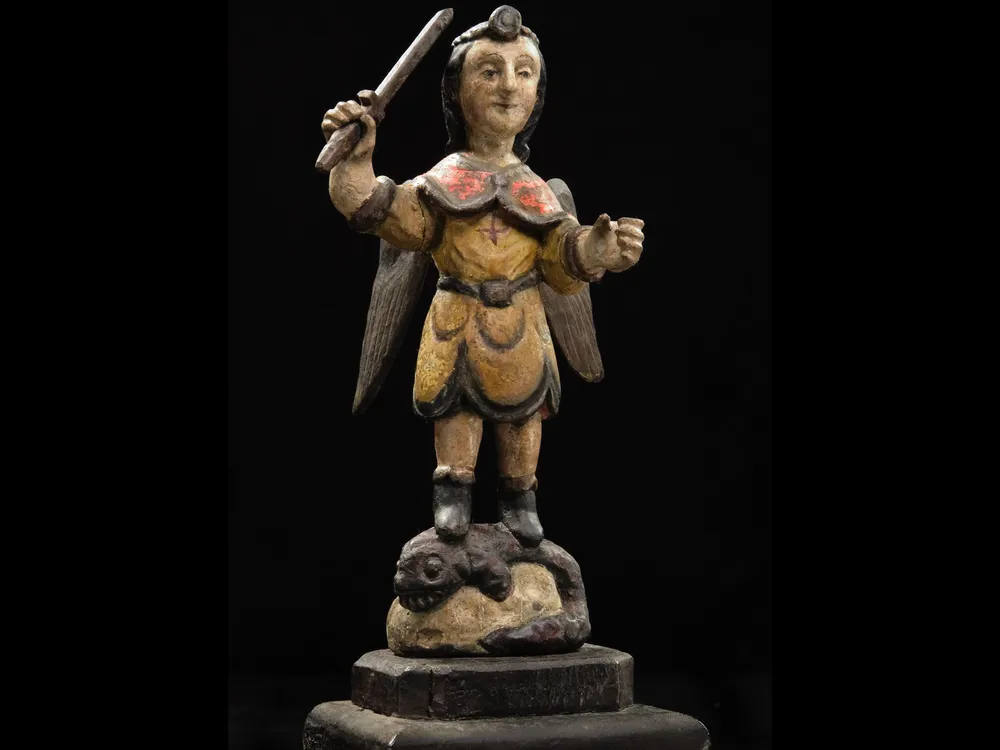 Carved wooden figure of San Miguel en Lucha con el Demonio