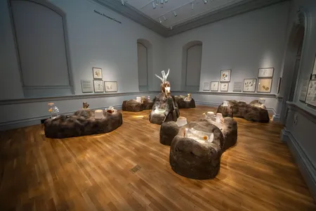 The exhibit room appears nearly monochromatic and devoid of life before the augmented reality app reveals Ruffner's invented plants.