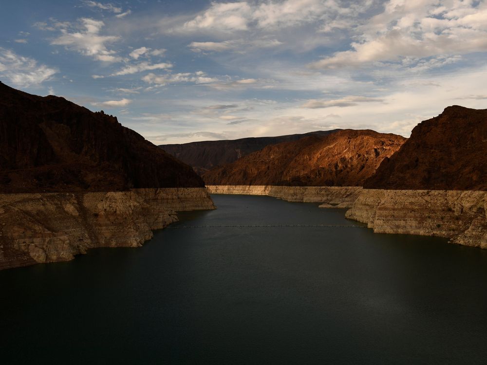 water in a lake appears several feet lower than a line on the canyon walls where it used to reach