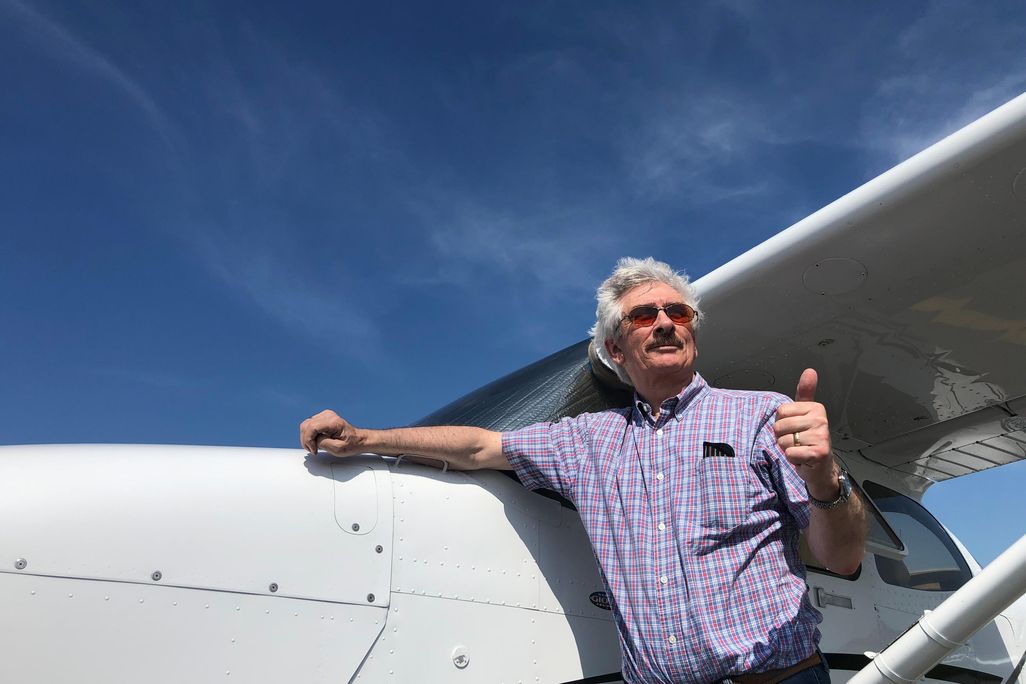 Barry Eccleston by his Cessna 172S giving thumbs up