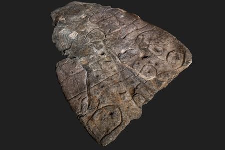 The markings on the slab may represent river systems, settlements, fields and barrows.