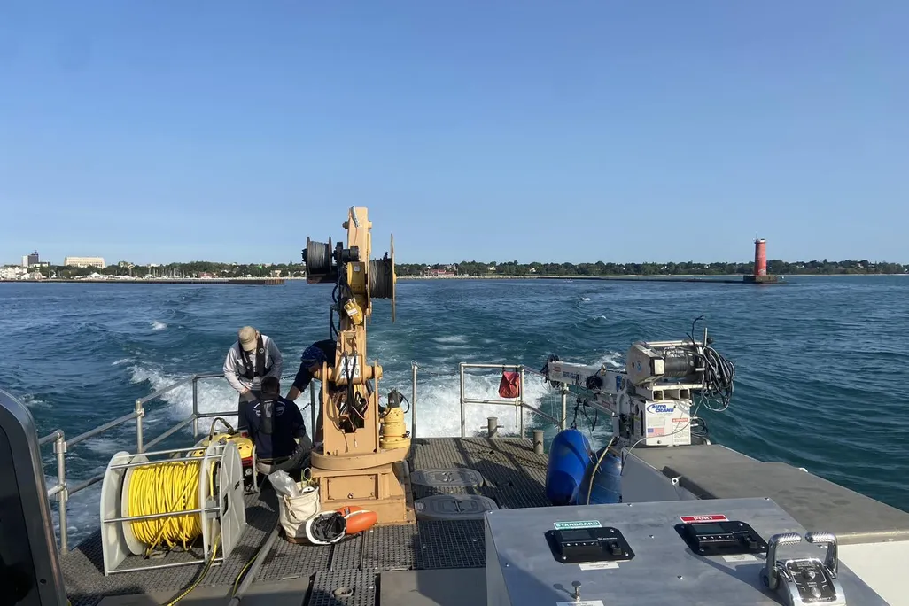 Back of a boat with equipment on it overlooked the water
