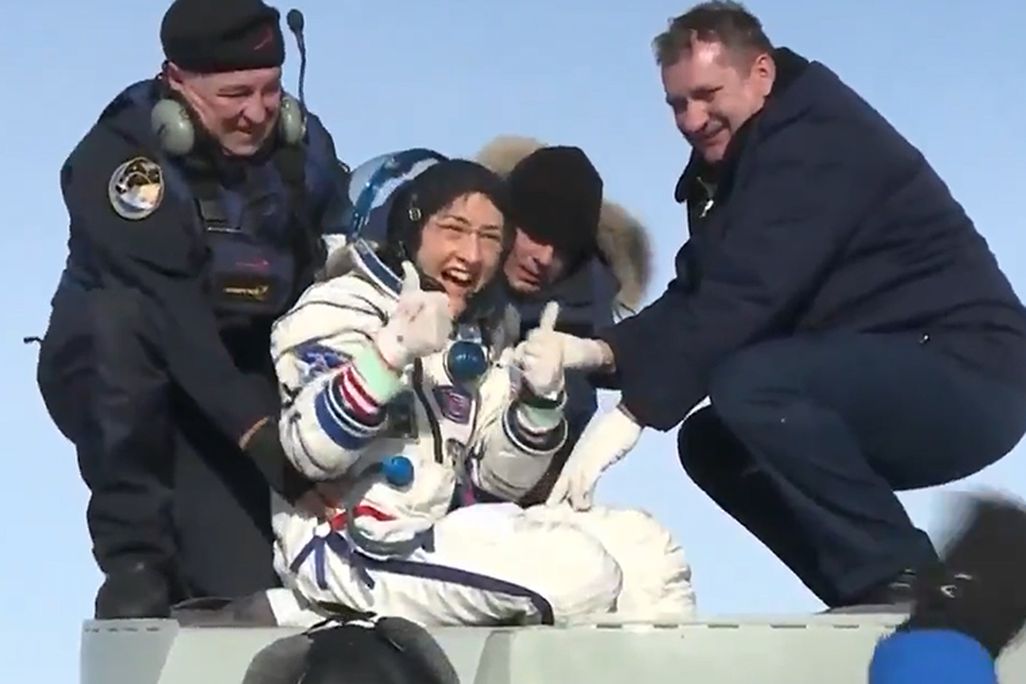 Christina Koch exits the Soyuz spacecraft, giving two thumbs up