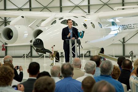 Standing in front of WhiteKnightTwo, George Whitesides addresses a crowd at Virgin Galactic's hangar at the Mojave Air and Space Port in California.