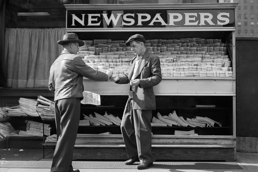 Man buying newspaper in NYC