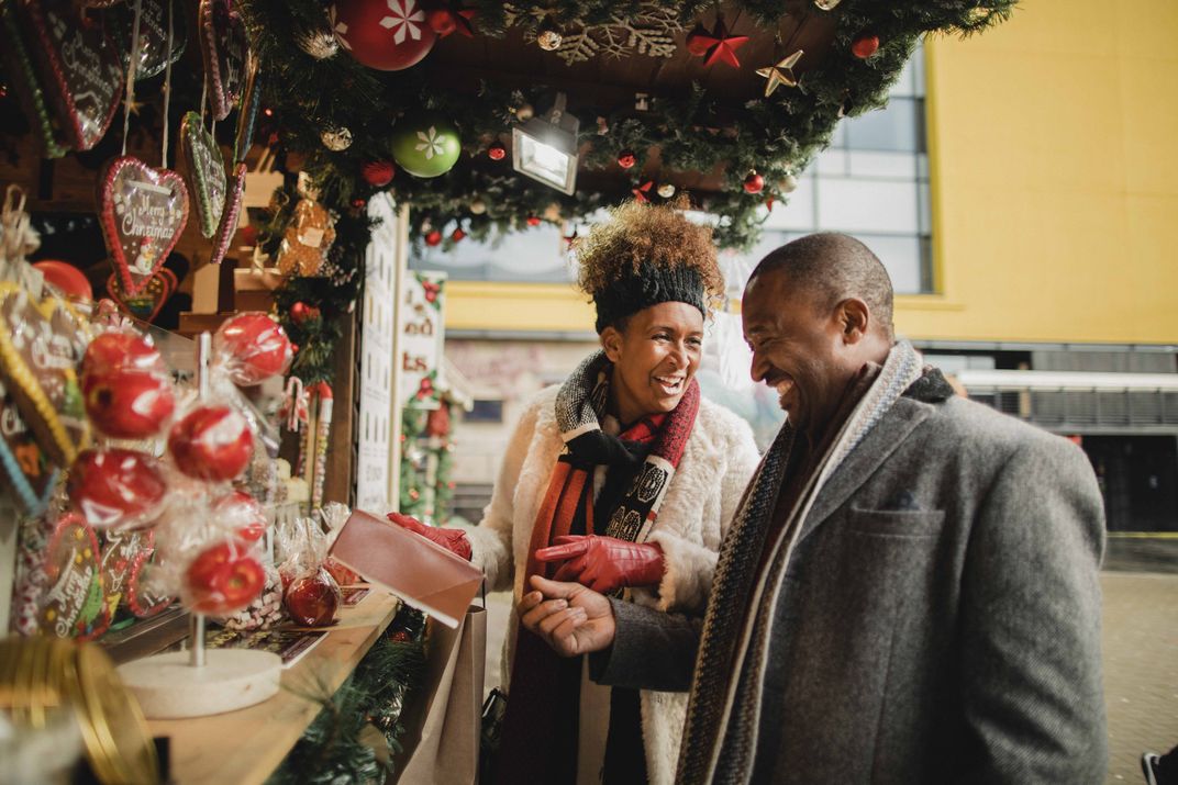 Couple enjoying the treasures of a Christmas market. Credit: AMA Waterways