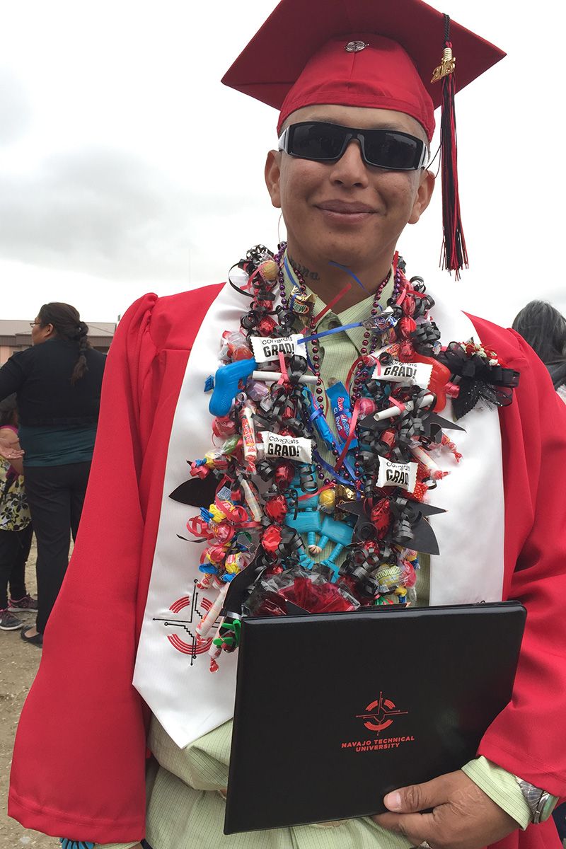 Fernando Yazzie shows off his diploma after the ceremony at Navajo Technical University.