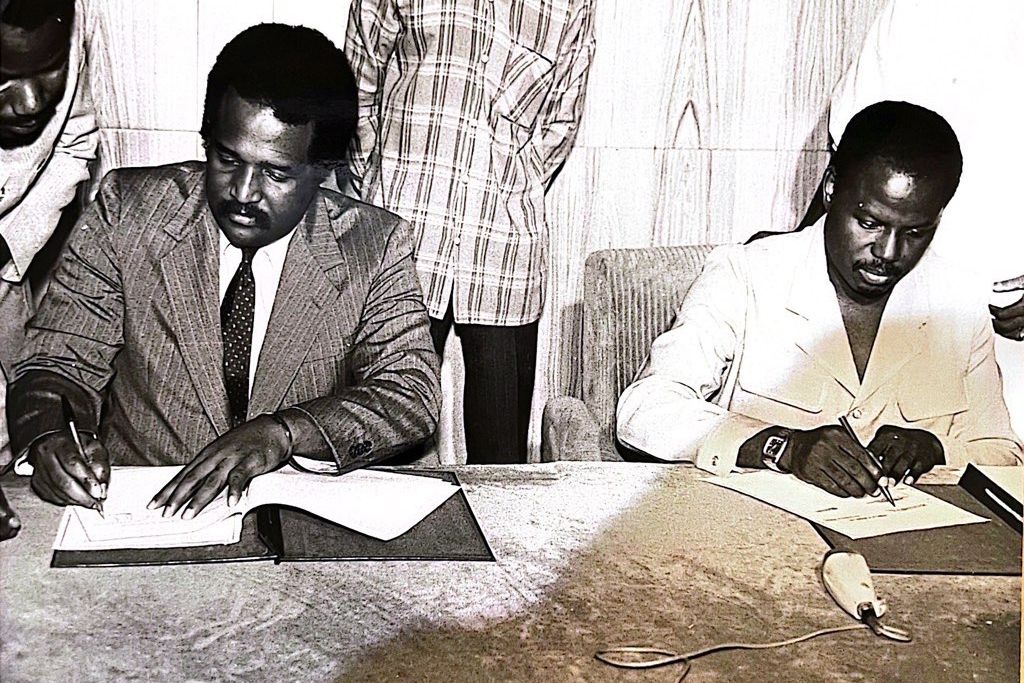 John H. Smith signs a document