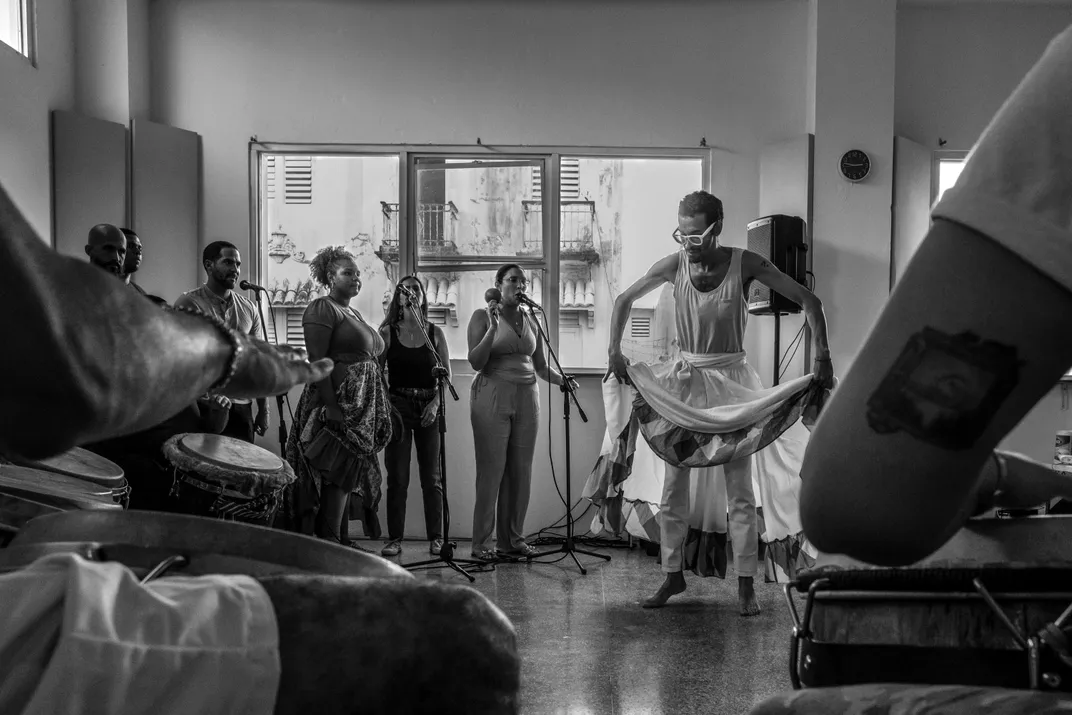 a black and white photograph shows a dancing instructor teaching a class of students