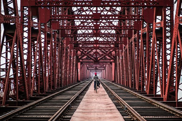 A man returning home with cycle on hrading bridge thumbnail